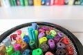 Coloring pens in mesh container against blurred bookshelf