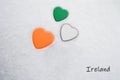 Colors of the irish flag Shamrock Green, White, Mango Tango painted on three hearts. Royalty Free Stock Photo