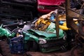 Colors on the junkyard, crushed turquoise scrap car, yellow garb