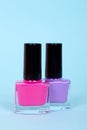 Colors nail polish bottles, make up. Isolated on blue background