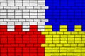 Colors of national flags of Poland and Ukraine on a brick wall