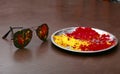 Colors in plate and a eye wear sun glass near it. Brown background, selective focus on obj Colors in plate.
