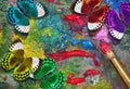colors of rainbow. colorful tropical morpho butterflies on an artist\'s palette with a brush and strokes of oil paint Royalty Free Stock Photo