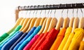 Colors of rainbow LGBT. Variety of casual clothes on wooden hangers