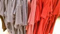 Colors of rainbow. Variety of casual shirts, t-shirts on hangers in a store. Cloth cotton of various bright colors close-up.