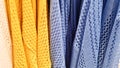 Colors of rainbow. Variety of casual shirts, t-shirts on hangers in a store. Cloth cotton of various bright colors close-up.