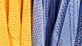 Colors of rainbow. Variety of casual shirts, t-shirts on hangers in a store. Cloth cotton of various bright colors close-up.