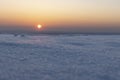 Sunset over the snowy plain