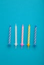 Coloruful birthday candles on blue background. Birthday celebration. Vertical photo Royalty Free Stock Photo