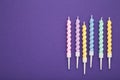 Coloruful birthday candles on violet background. Birthday celebration. Vertical photo Royalty Free Stock Photo