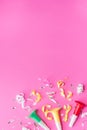 Colorul party streamers on pink background. Celebration concept. Flat lay Royalty Free Stock Photo