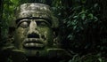 Colossal Olmec Head stone statue. Ancient stone monument in the lush deep jungle forest. Royalty Free Stock Photo