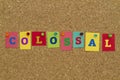 Colossal word written on colorful sticky notes. Royalty Free Stock Photo