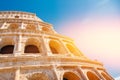 Colosseum or Coliseum ancient ruins background blue sky Rome, Italy, view from below, stone arches and sunrays Royalty Free Stock Photo