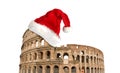 Colosseum or Coliseum with Santa Claus hat isolated on white background. Symbol of Rome and Italy Royalty Free Stock Photo