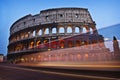 The Colosseum with some bus lights in front Royalty Free Stock Photo