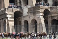 The Colosseum. Walking tour. Tourists and chariot