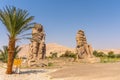 Colossi of Memnon statues under the sunlight and a blue sky in Luxor, Egypt Royalty Free Stock Photo