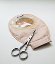 Colostomy bag with scissors