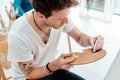 Colour brings the life to a picture. a handsome young artist squeezing paint onto a palette during an art class in the Royalty Free Stock Photo