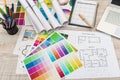 Colour palettes with house plan on desk top view. Designer working at new project