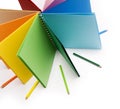 Colour pencils and colored notebook Royalty Free Stock Photo