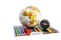 Colour pencils with globe, compass and education note