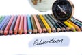 Colour pencils with globe, compass and education note