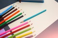Colour pencils with notebooks and lying on pastel beige background. Back to school concept sign written. Colorful art studying and