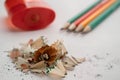 Colour pencils pile of sawdust and red sharpener on a white background Royalty Free Stock Photo