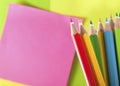 Colour pencils and postit for reminder note Royalty Free Stock Photo