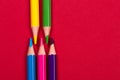 Colour pencils on red paper from left side Royalty Free Stock Photo