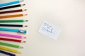 Colour pencils with sharpener lying on pastel beige background. Back to school concept sign written. Colorful art studying and