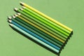 The concept of environmental protection: pencils in green shades on a green background top view.Let\'s paint the world green.