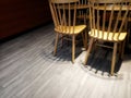 Colour photo of wooden chairs with dark shadow, low key and spotlight