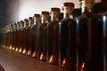 Colour scale gradation of whiskey and cognac infusion in bottles. bottle ranking by age time. Royalty Free Stock Photo