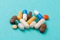 Colour tablets and pills on blue background