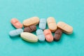 Colour tablets and pills on blue background