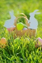 Coloured Easter Eggs In Basket Padded Out With Rabbit Decorations Royalty Free Stock Photo