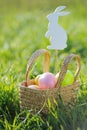 Coloured Easter eggs in basket padded out with rabbit decorations Royalty Free Stock Photo