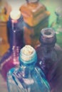 Coloured glass bottles on a rustic background Royalty Free Stock Photo