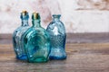 Coloured glass bottles on a rustic background Royalty Free Stock Photo