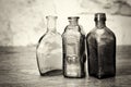 Coloured glass bottles on a rustic background Royalty Free Stock Photo