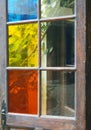 coloured glass panes in an old wooden door opening on to a garden