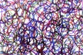 Coloured ink pen scribbled wavy messy tengled lines on white background