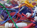 A tangled pile of brightly coloured skipping ropes on the floor