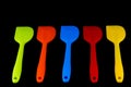 Coloured Kitchen Spatulas on a Black Background