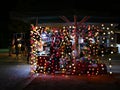 Coloured lights on a street stall in Athens, Greece with people beyond