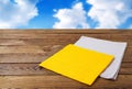 Coloured napkin,wooden table on blurred sky background Royalty Free Stock Photo