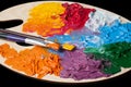 Coloured oil paint and brushes on the palette Royalty Free Stock Photo